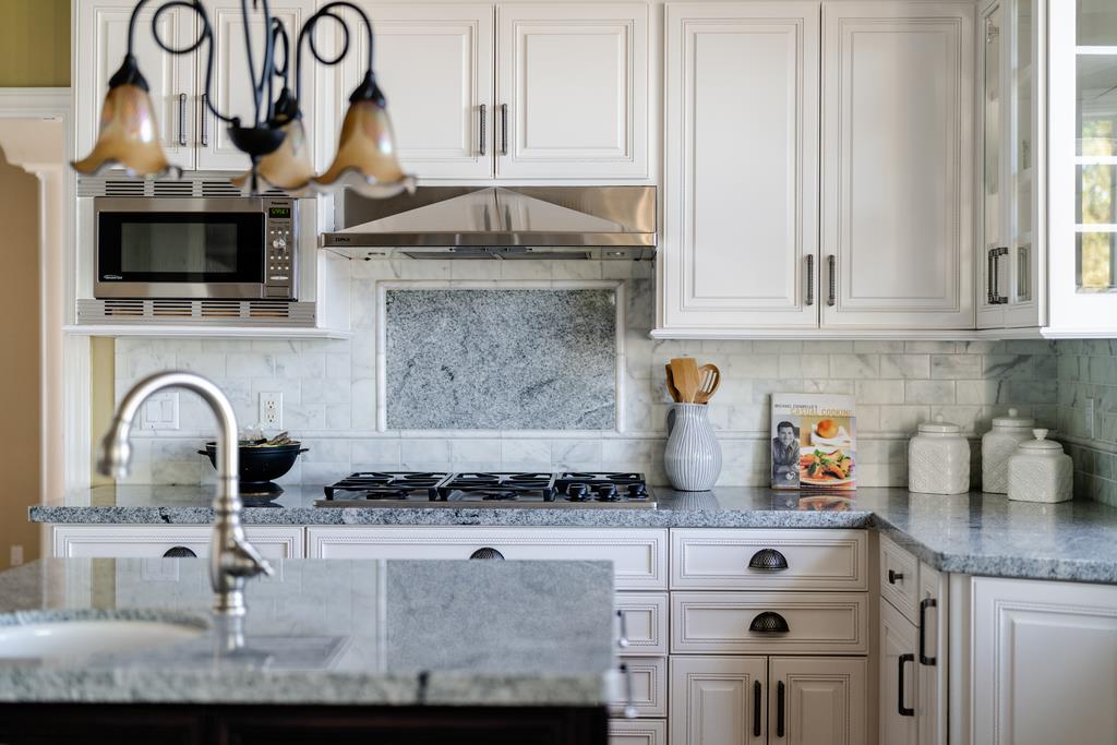 25220 Quail Ridge Road Los Gatos, CA 95033 - Photo 23 of 94 a kitchen with granite countertop a stove and a white cabinets