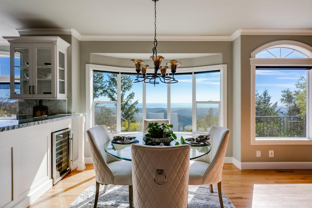 25220 Quail Ridge Road Los Gatos, CA 95033 - Photo 32 of 94 a dining room with furniture large windows and a chandelier