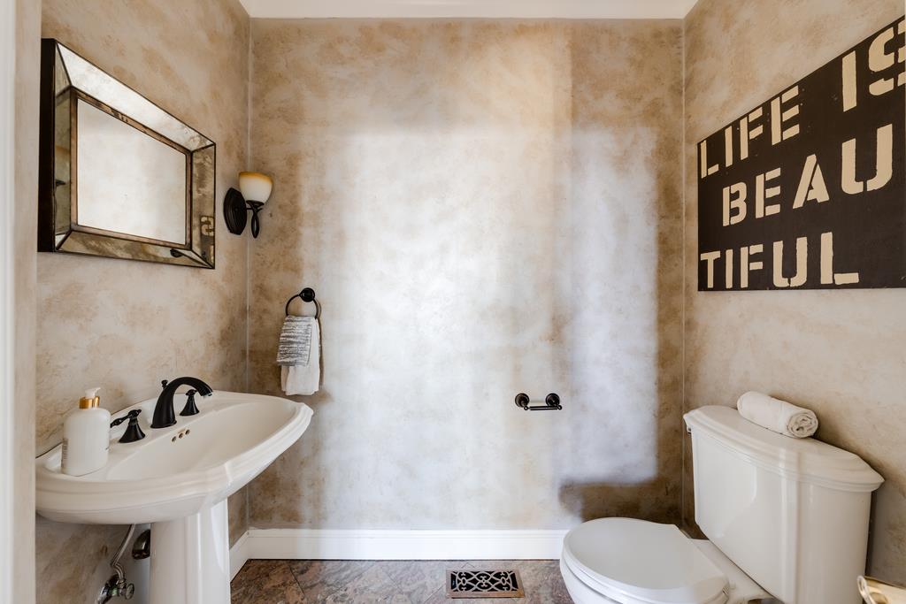 25220 Quail Ridge Road Los Gatos, CA 95033 - Photo 46 of 94 a bathroom with a sink and mirror with toilet