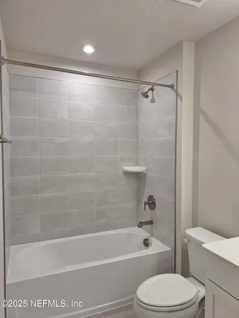 a bathroom with granite countertop and vanity