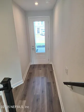 a view of houses with cars parked