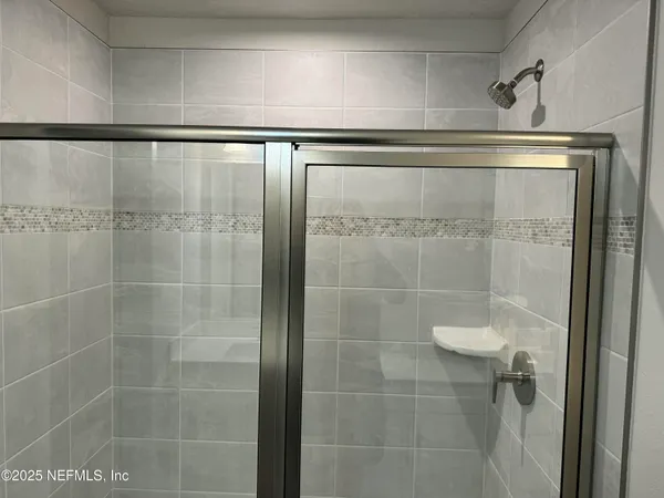 a white toilet sitting next to a shower
