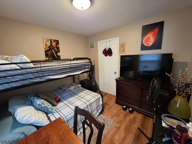 a living room with furniture and a flat screen tv with bookshelf