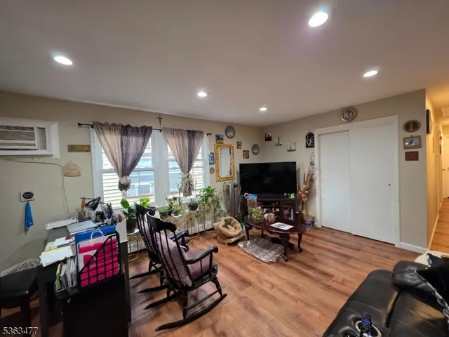 a view of a livingroom with workspace and a window