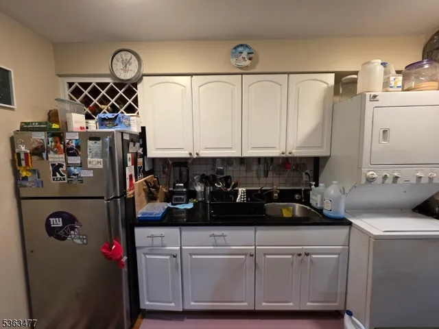 a kitchen with a refrigerator and a stove