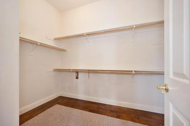 an empty room with a window and a ceiling fan