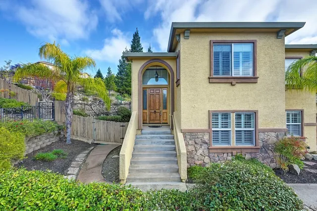 a front view of a house with a garden