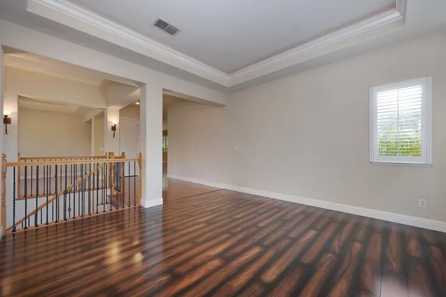 a view of a hallway view with wooden floor and staircase
