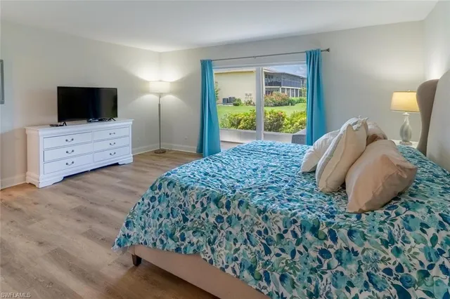 a bedroom with a bed and flat screen tv