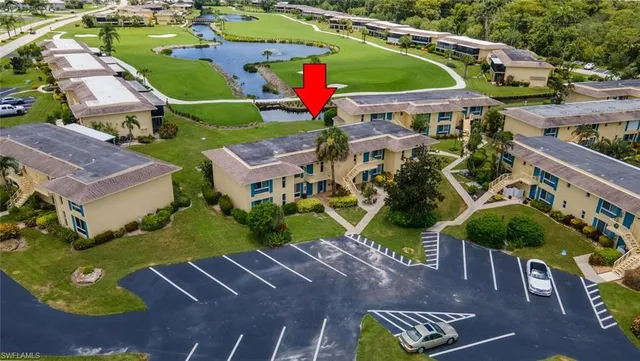 an aerial view of a house with a garden and lake view