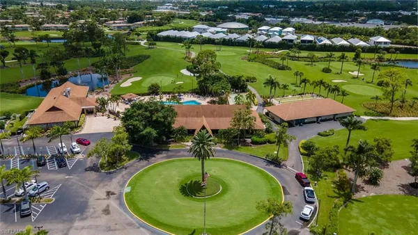 an aerial view of residential houses with outdoor space and lake view