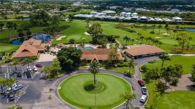 an aerial view of residential houses with outdoor space and lake view