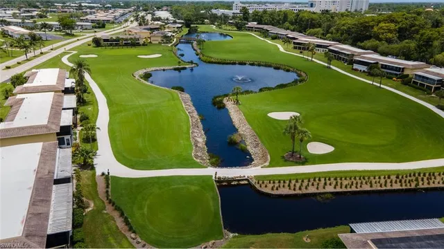 an aerial view of a golf course with swimming pool and outdoor space