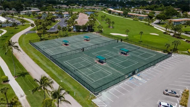 an aerial view of a house with a garden and lake view