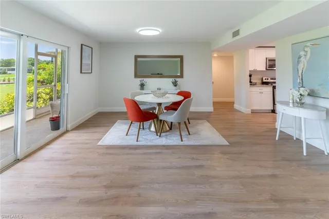 a dining room with furniture and window