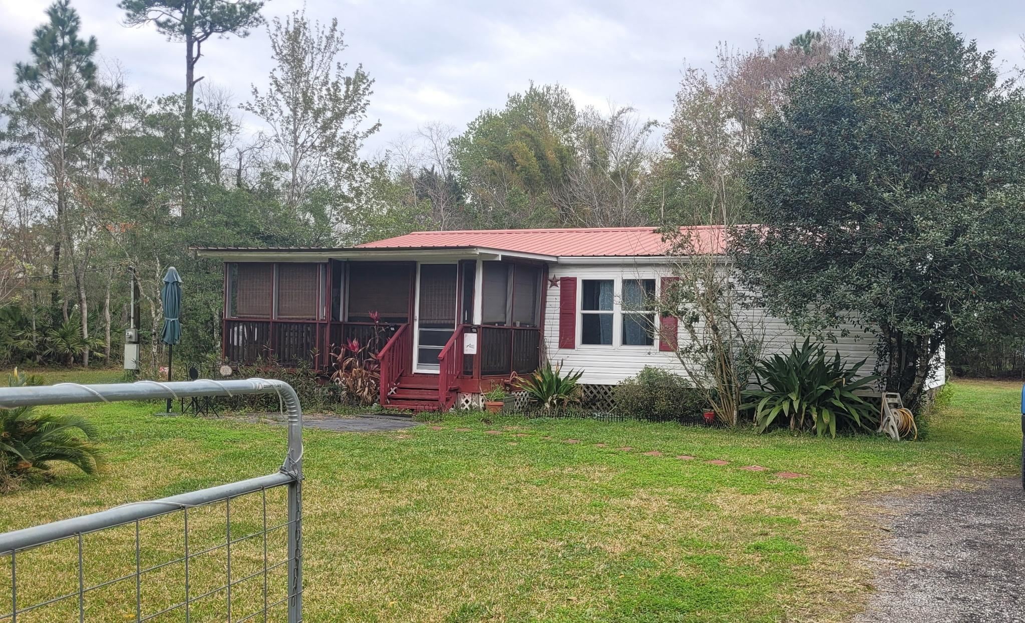 3180 Green Acres Road St. Augustine, FL 32084 - Photo 1 of 24 a view of a house with a yard and sitting area