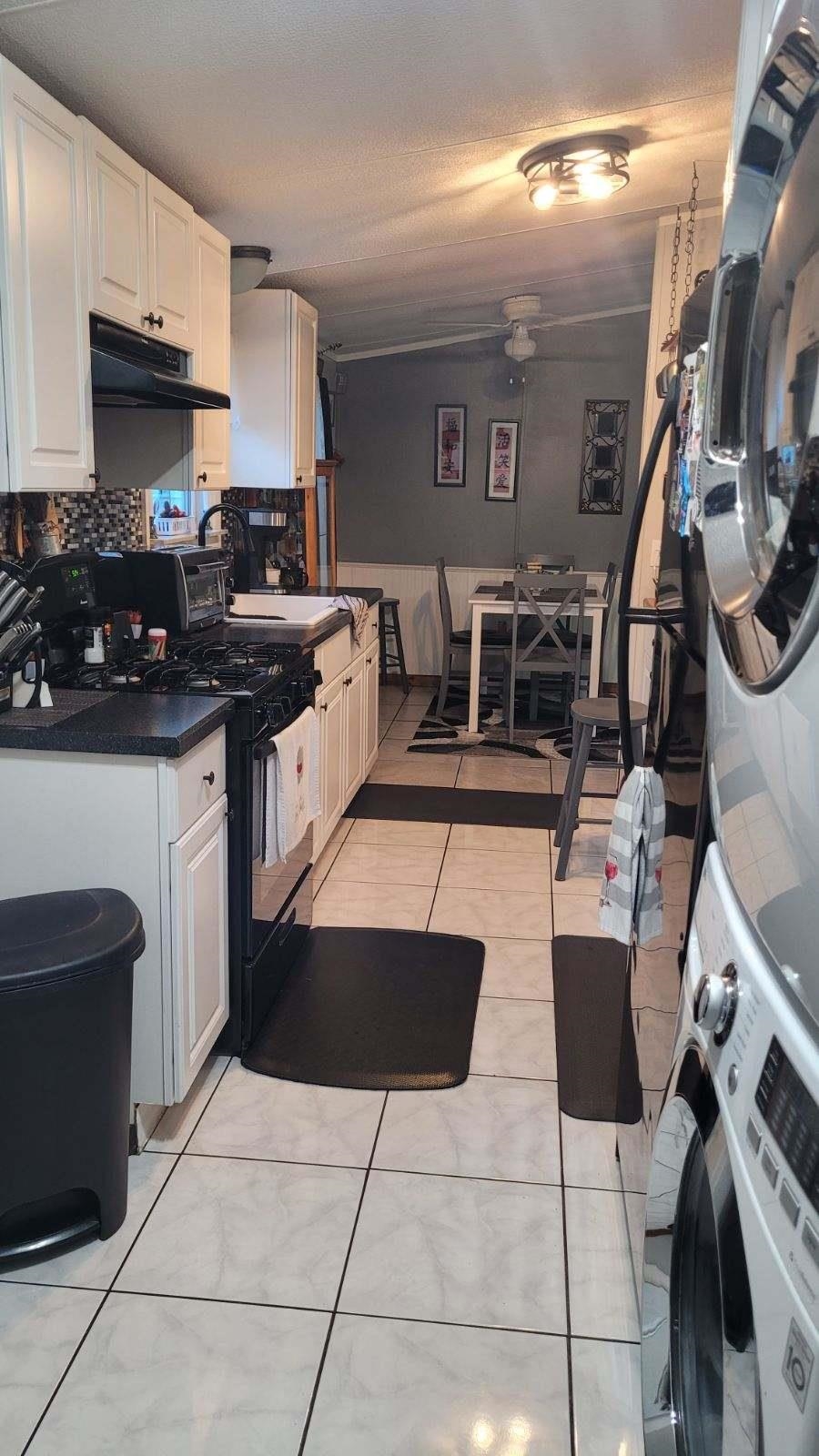 3180 Green Acres Road St. Augustine, FL 32084 - Photo 11 of 24 a kitchen with stainless steel appliances granite countertop a sink and a stove