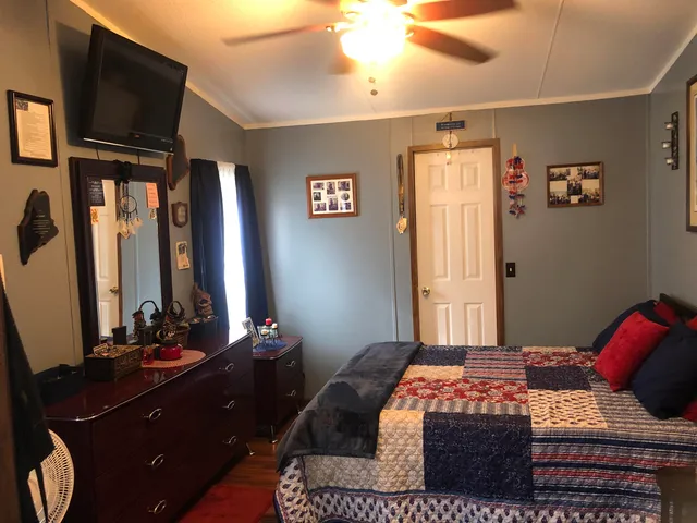 a bedroom with a bed and flat screen tv