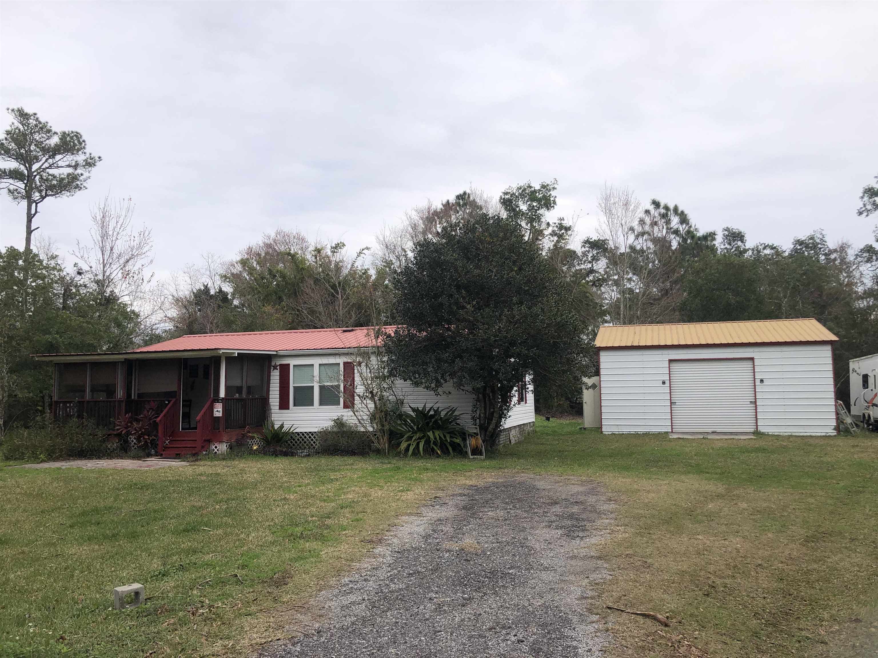 3180 Green Acres Road St. Augustine, FL 32084 - Photo 3 of 24 a view of a house with a yard and sitting area