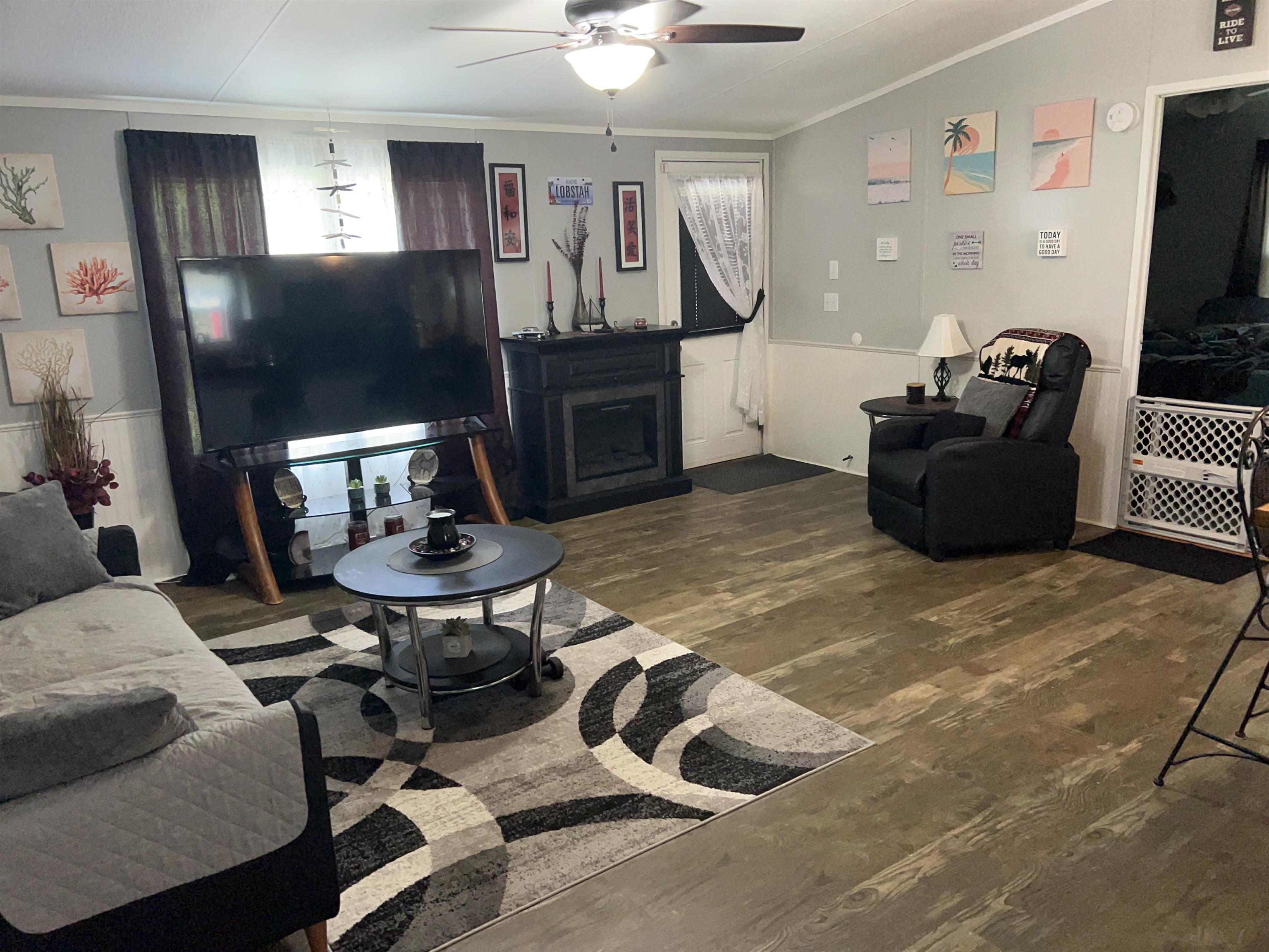 3180 Green Acres Road St. Augustine, FL 32084 - Photo 8 of 24 a living room with furniture a flat screen tv and a fireplace