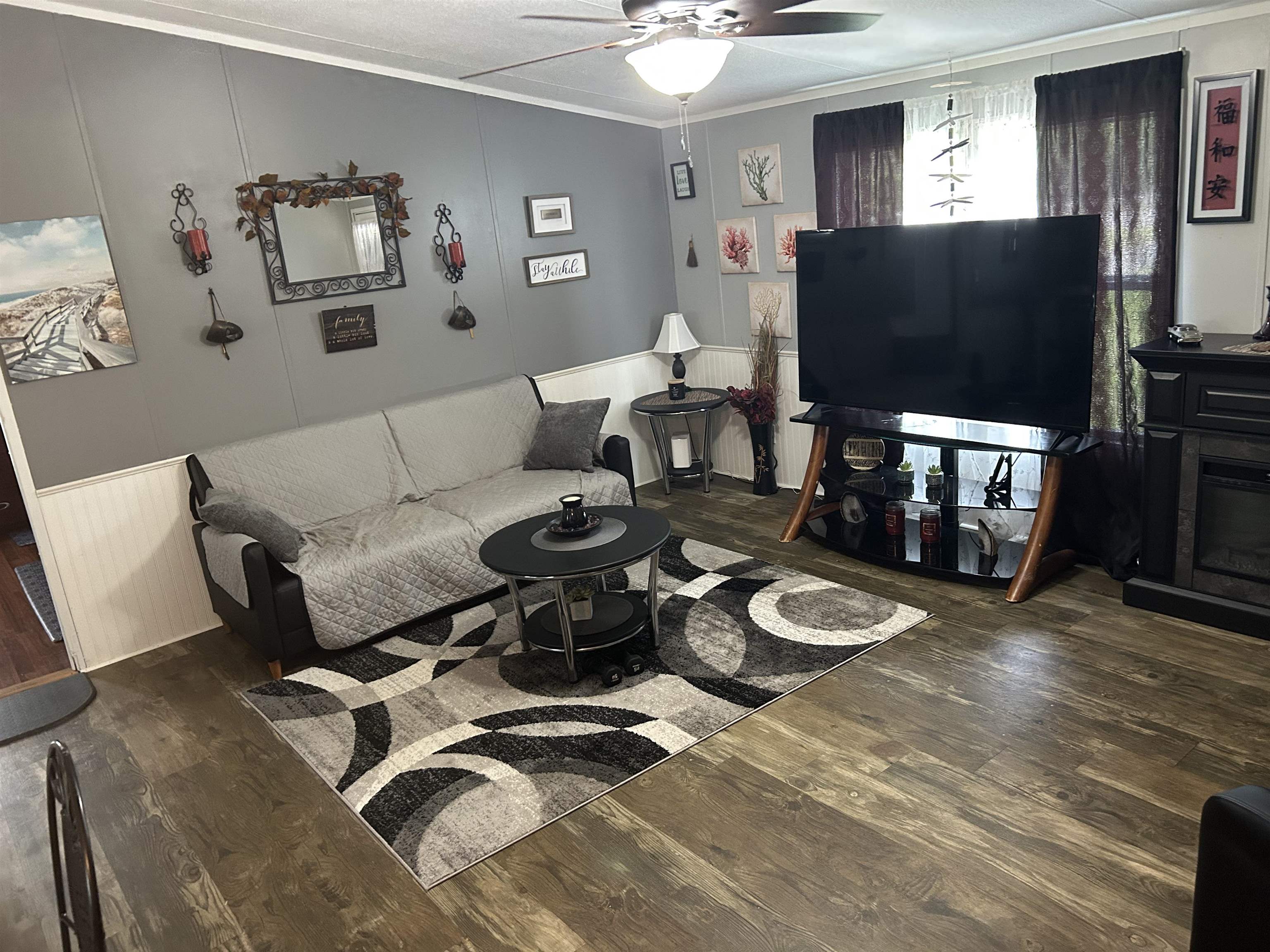 3180 Green Acres Road St. Augustine, FL 32084 - Photo 9 of 24 a living room with furniture a flat screen tv and a window