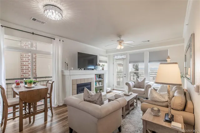 a living room with furniture a flat screen tv and a fireplace