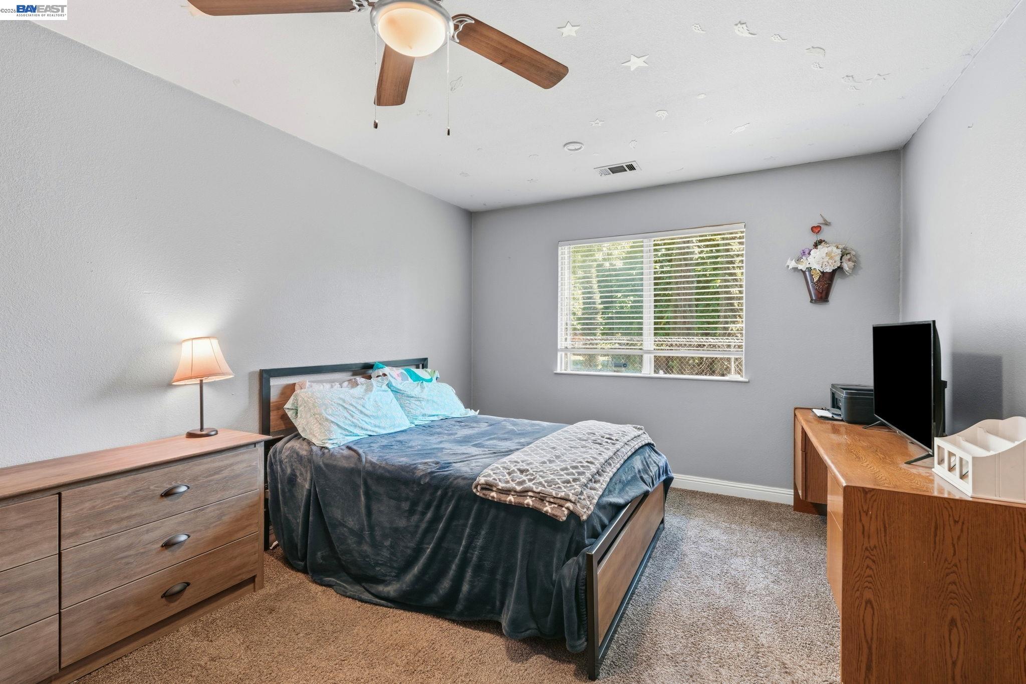 10378 South Priest Road French Camp, CA 95231 - Photo 27 of 44 a bedroom with a bed and wooden floor