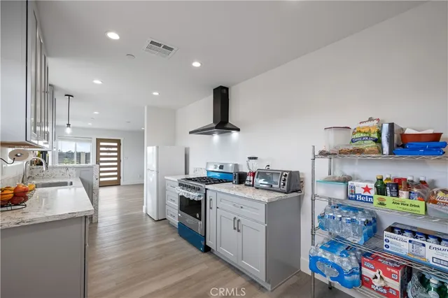 a kitchen with stainless steel appliances granite countertop a stove and a sink