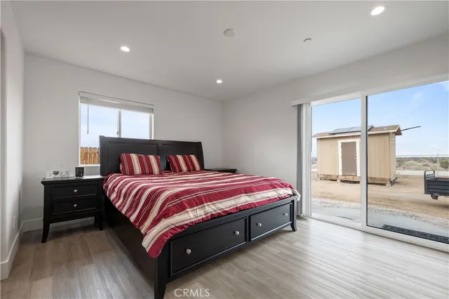 a bedroom with a bed and a large window