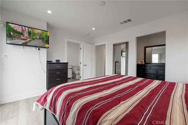 a bedroom with a bed and a mirror