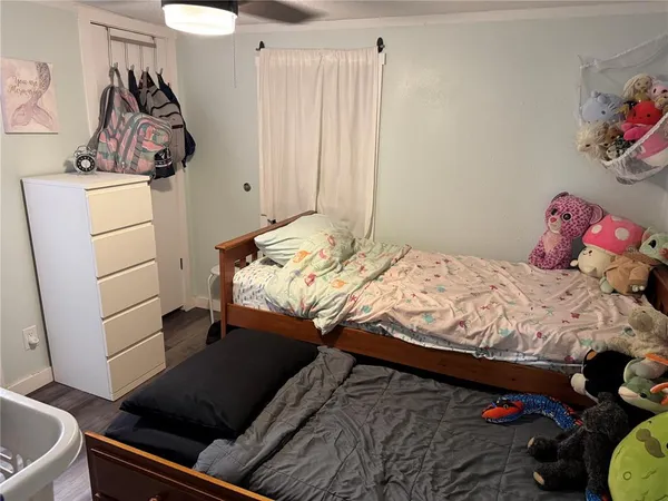 a bed sitting in a bedroom next to a window