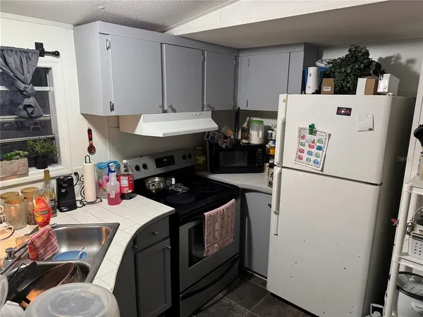 a kitchen with a refrigerator and a stove
