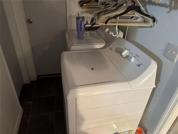 a close view of a utility room with dryer and washer