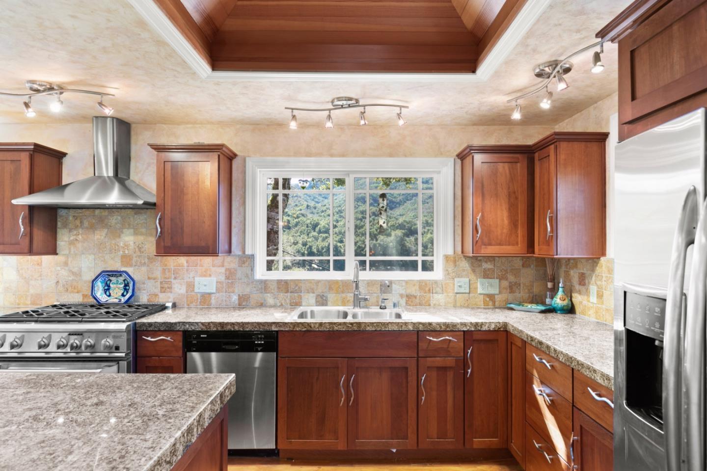 38025 Poppy Tree Lane Carmel Valley, CA 93924 - Photo 13 of 47 a kitchen with stainless steel appliances granite countertop a sink stove and refrigerator