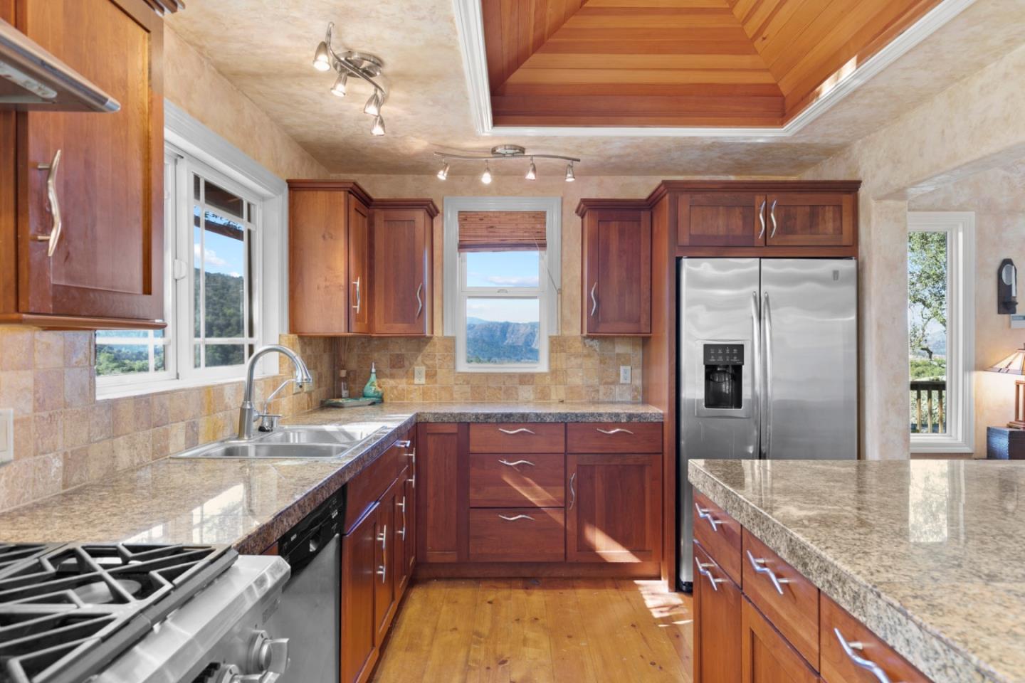 38025 Poppy Tree Lane Carmel Valley, CA 93924 - Photo 14 of 47 a kitchen with stainless steel appliances granite countertop a sink stove and refrigerator
