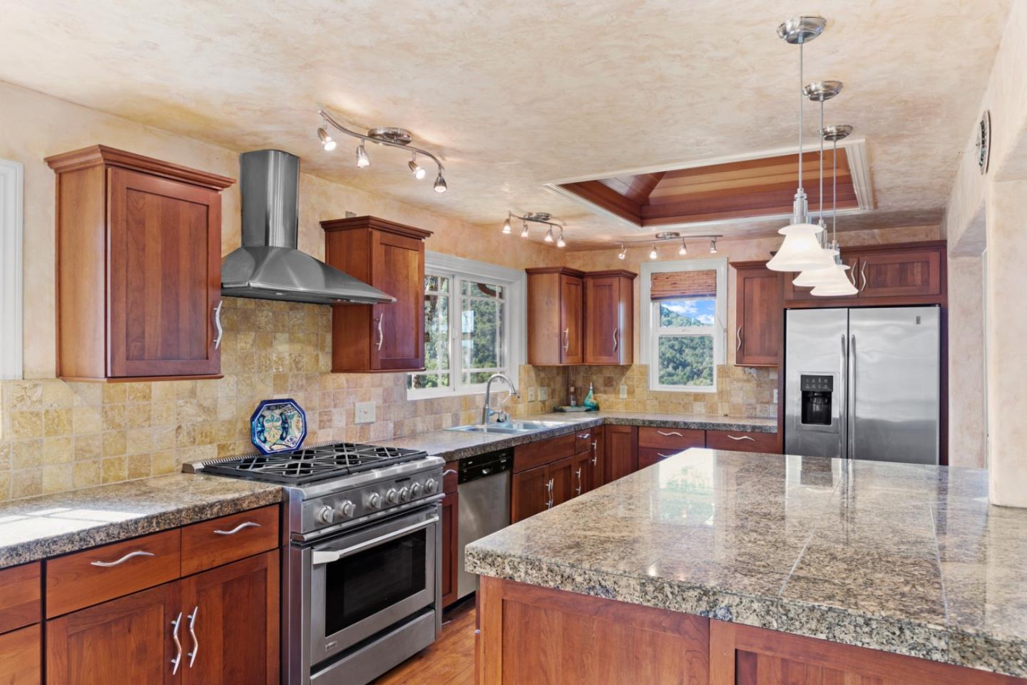 38025 Poppy Tree Lane Carmel Valley, CA 93924 - Photo 15 of 47 a kitchen with stainless steel appliances granite countertop a sink stove and refrigerator