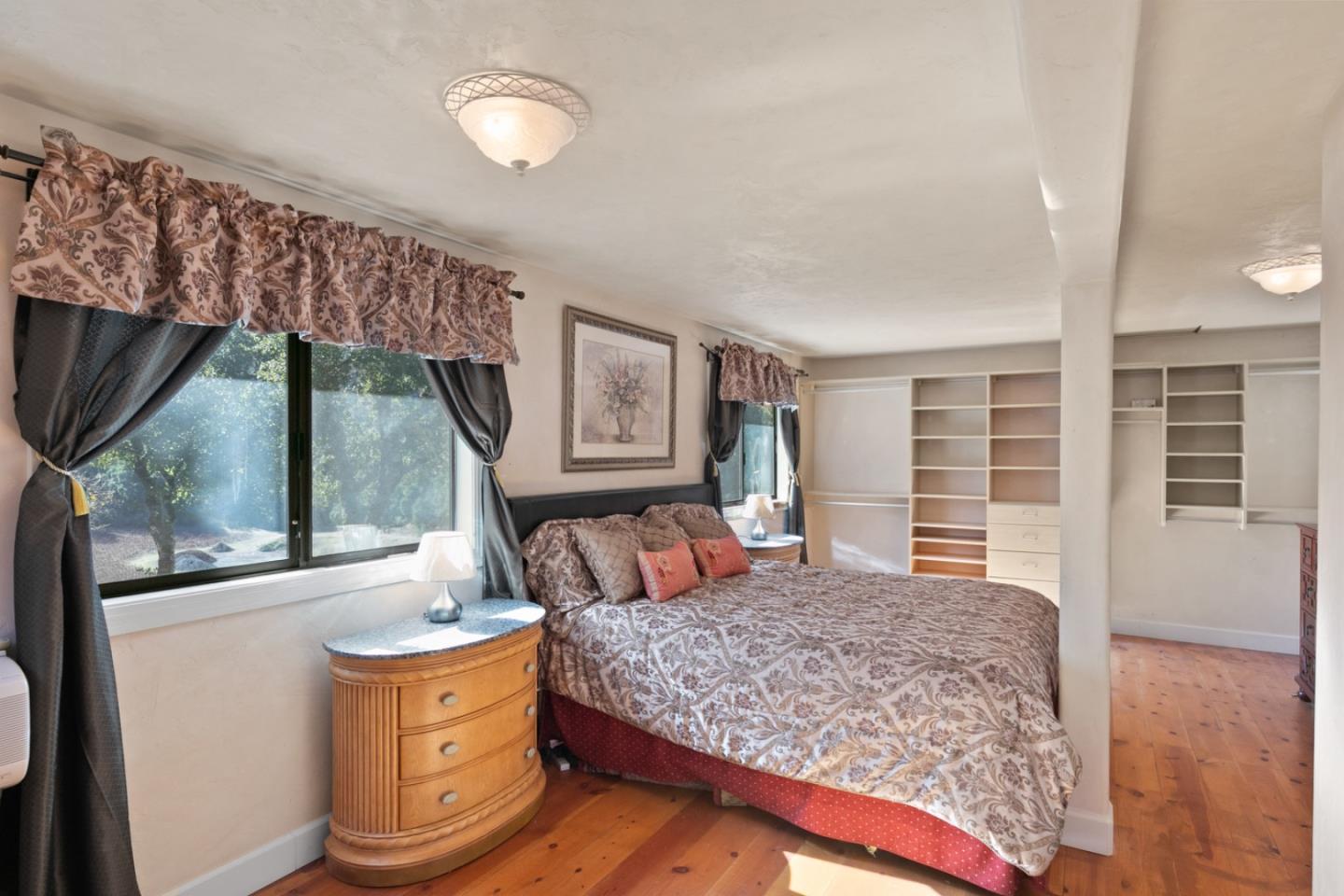 38025 Poppy Tree Lane Carmel Valley, CA 93924 - Photo 21 of 47 a bedroom with a large bed and a flat tv screen