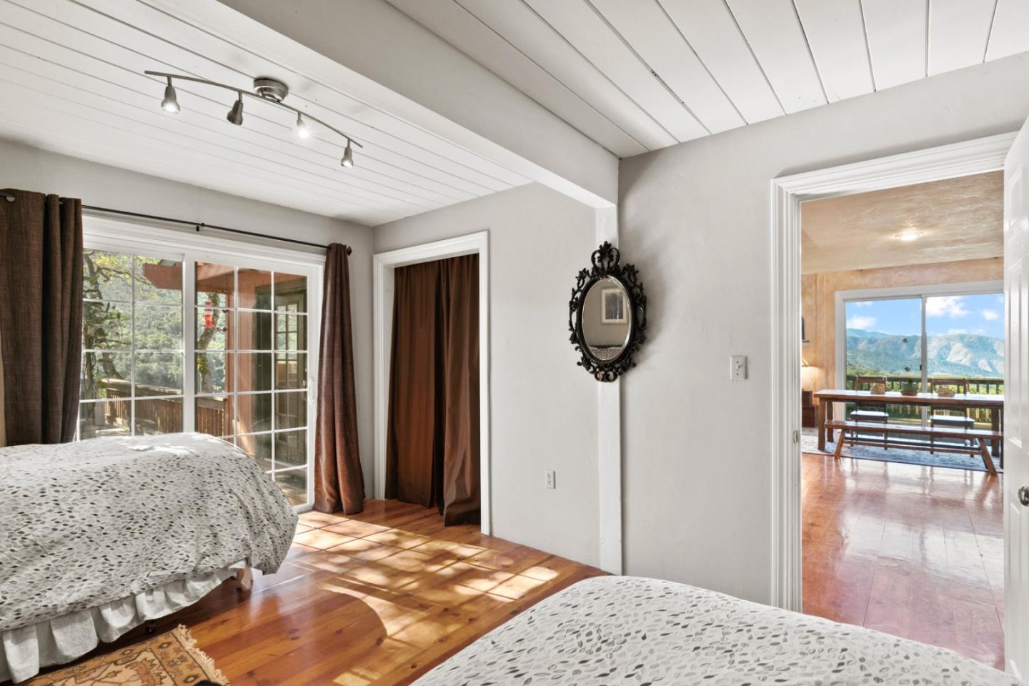 38025 Poppy Tree Lane Carmel Valley, CA 93924 - Photo 28 of 47 a bedroom with a bed a mirror and windows