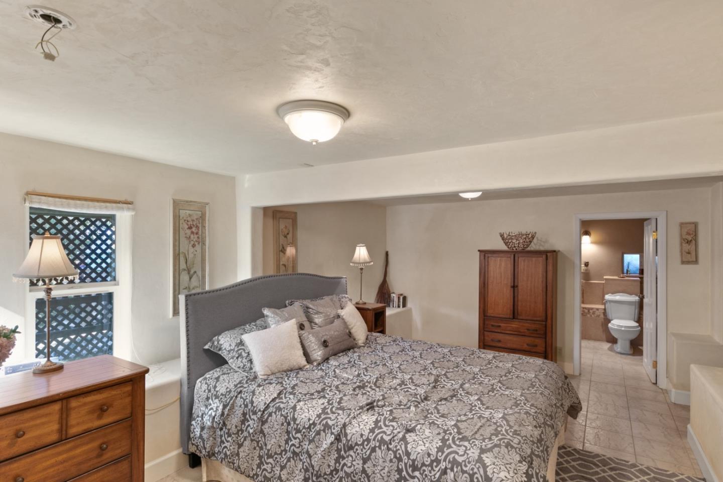 38025 Poppy Tree Lane Carmel Valley, CA 93924 - Photo 34 of 47 a bedroom with a large bed and a dresser