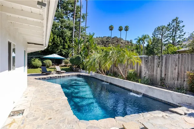 a view of backyard with wooden fence