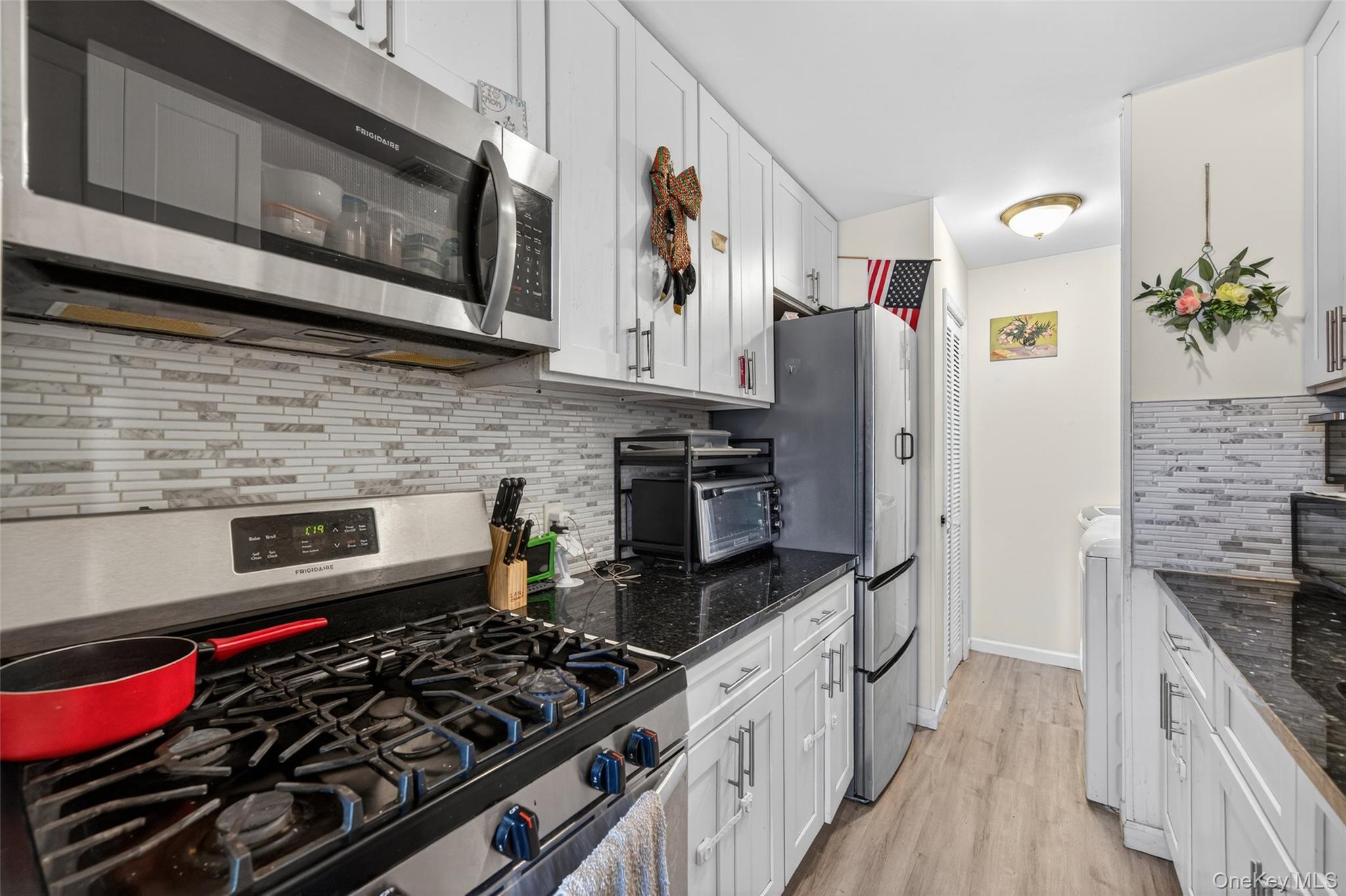 276 Temple Hill Road, Unit 2414 New Windsor, NY 12553 - Photo 13 of 29 a kitchen with stainless steel appliances granite countertop a stove and a microwave