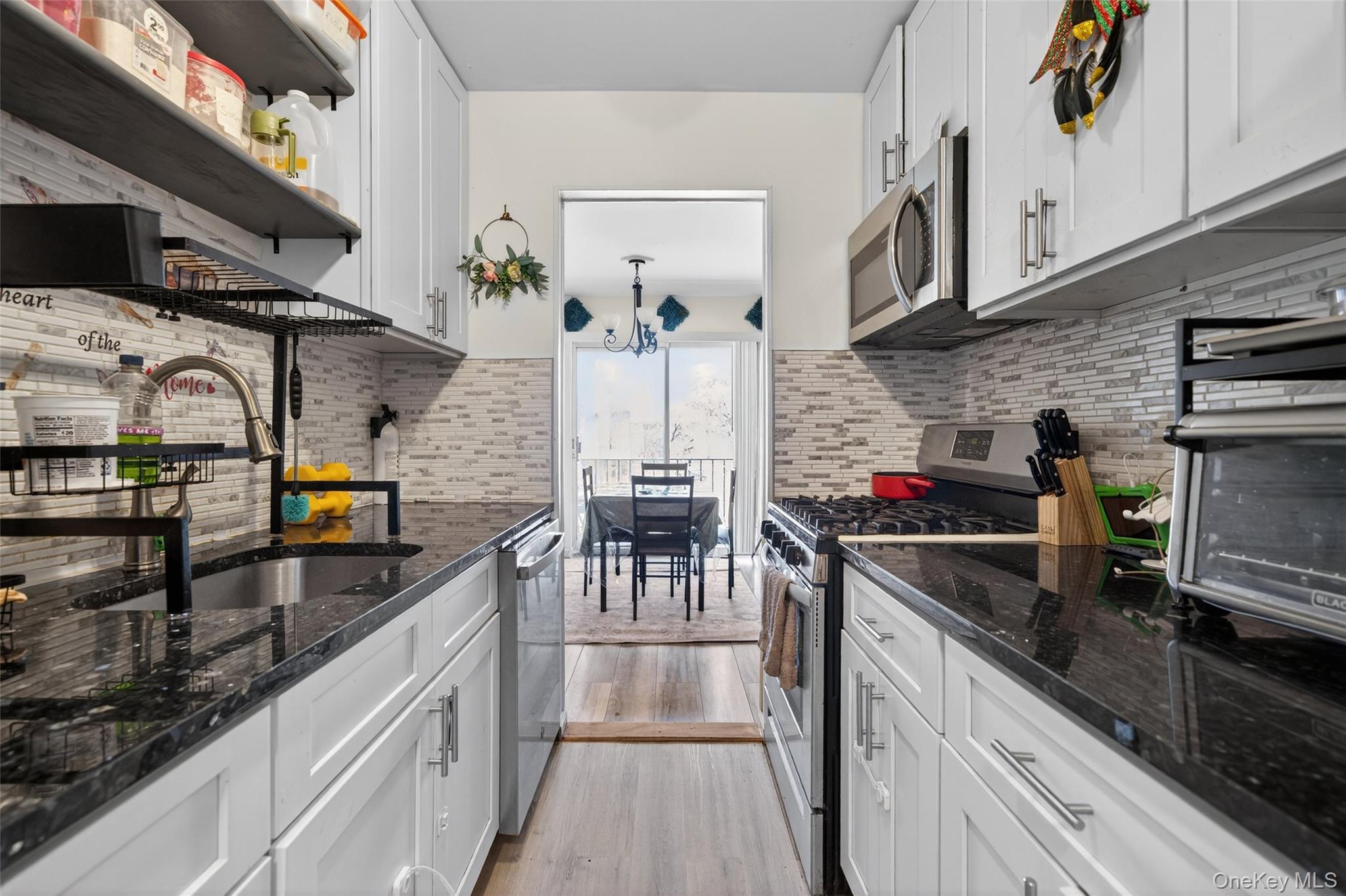 276 Temple Hill Road, Unit 2414 New Windsor, NY 12553 - Photo 17 of 29 a kitchen with stainless steel appliances granite countertop a stove a sink and a microwave