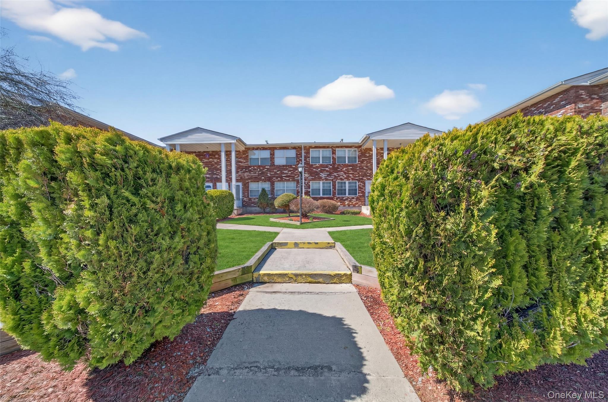 276 Temple Hill Road, Unit 2414 New Windsor, NY 12553 - Photo 3 of 29 a view of a pathway with a garden