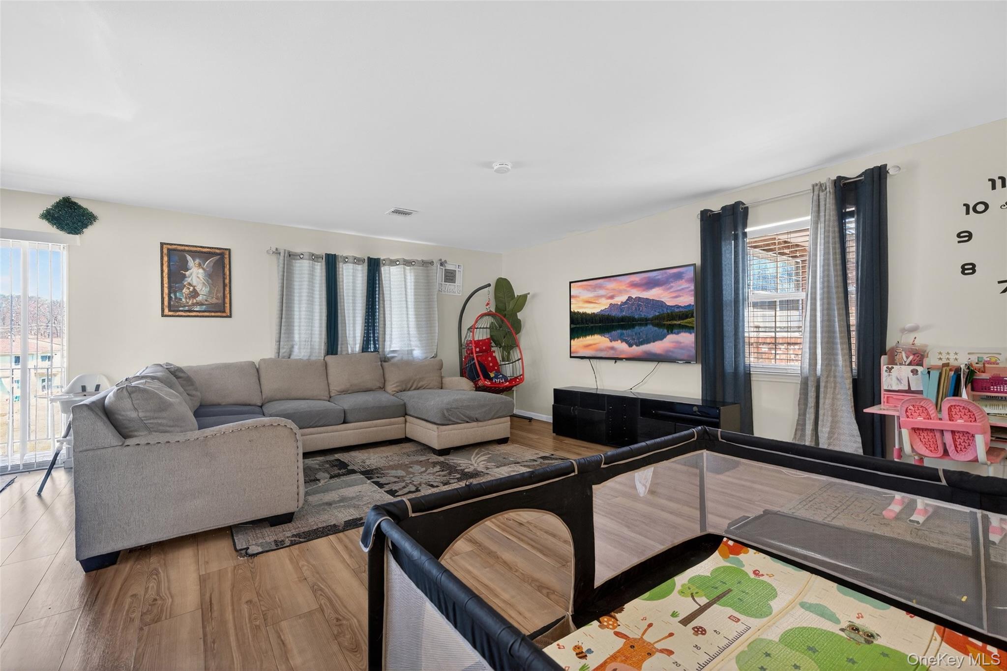 276 Temple Hill Road, Unit 2414 New Windsor, NY 12553 - Photo 5 of 29 a living room with furniture and a flat screen tv