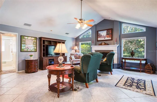 a living room with furniture a window and a fireplace