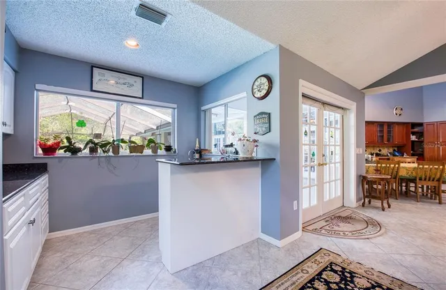 a view of kitchen with refrigerator and window