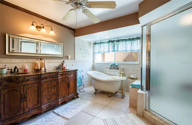 a living room with furniture a bookshelf and a window