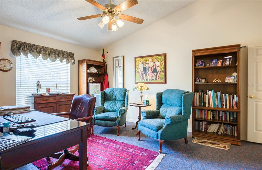 4901 Hallstead Way Tampa, FL 33647 - Photo 30 of 47 a living room with furniture a bookshelf and a window