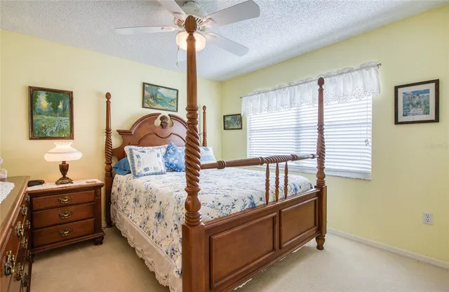 a view of a bedroom with a balcony a bed and a window