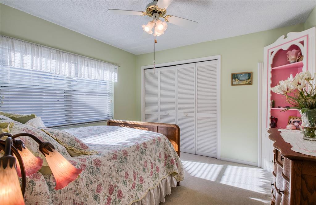 4901 Hallstead Way Tampa, FL 33647 - Photo 36 of 47 a bedroom with a bed and a chandelier